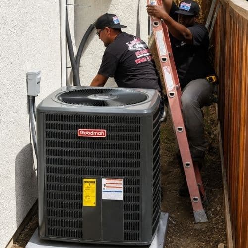 In Demand technicians installing an outdoor air conditioning system