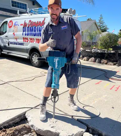 In Demand Plumbing tech working on residential driveway in Antioch.